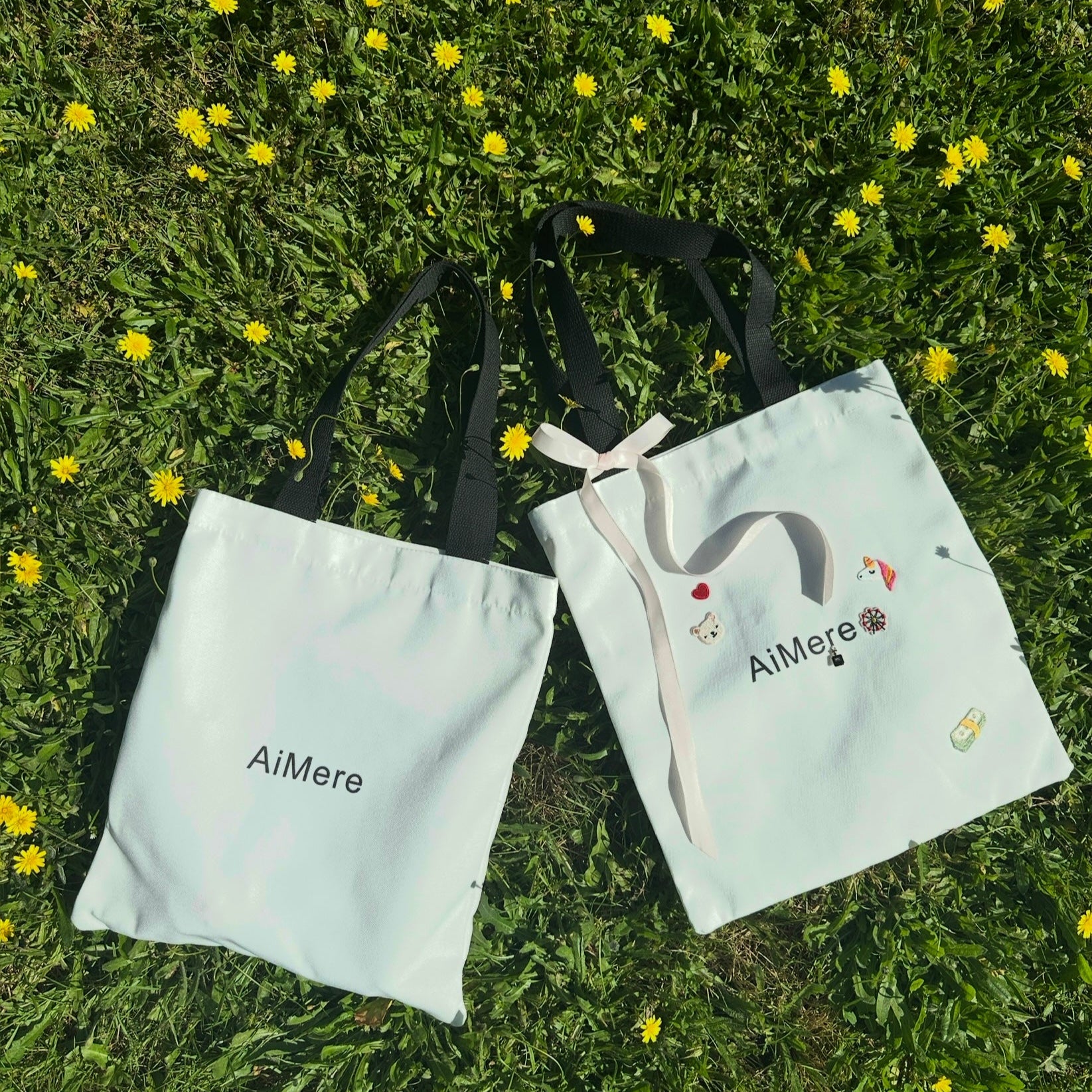 Two white bags with 'AiMere' branding on a grassy background with yellow flowers.
canvas tote bag, customizable tote, AiMere tote, designer bag protection, everyday carry, DIY tote bag, travel tote, work bag, grocery tote