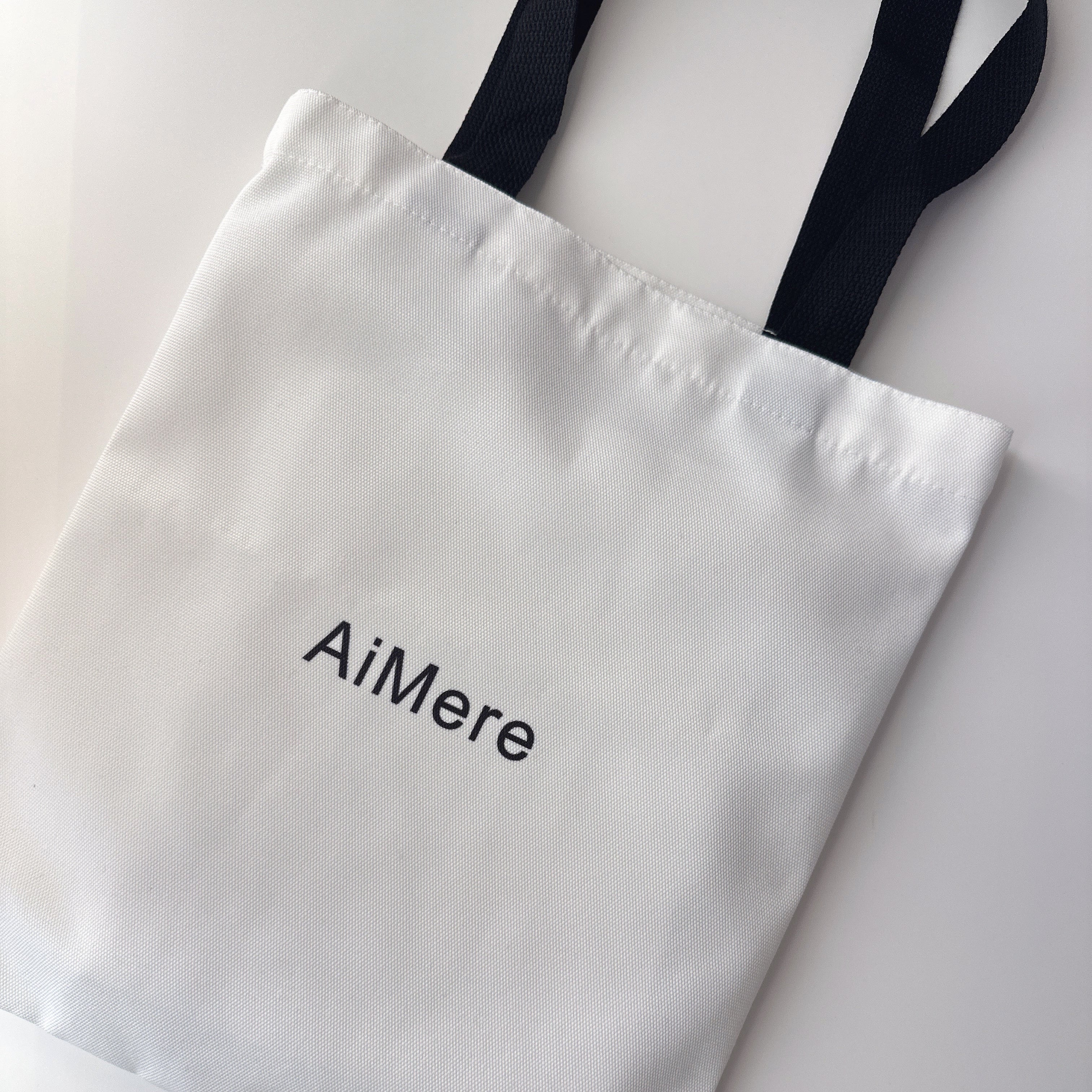 White tote bag with 'AiMere' text on a light gray background. Canvas tote bag

canvas tote bag, customizable tote, AiMere tote, designer bag protection, everyday carry, DIY tote bag, travel tote, work bag, grocery tote