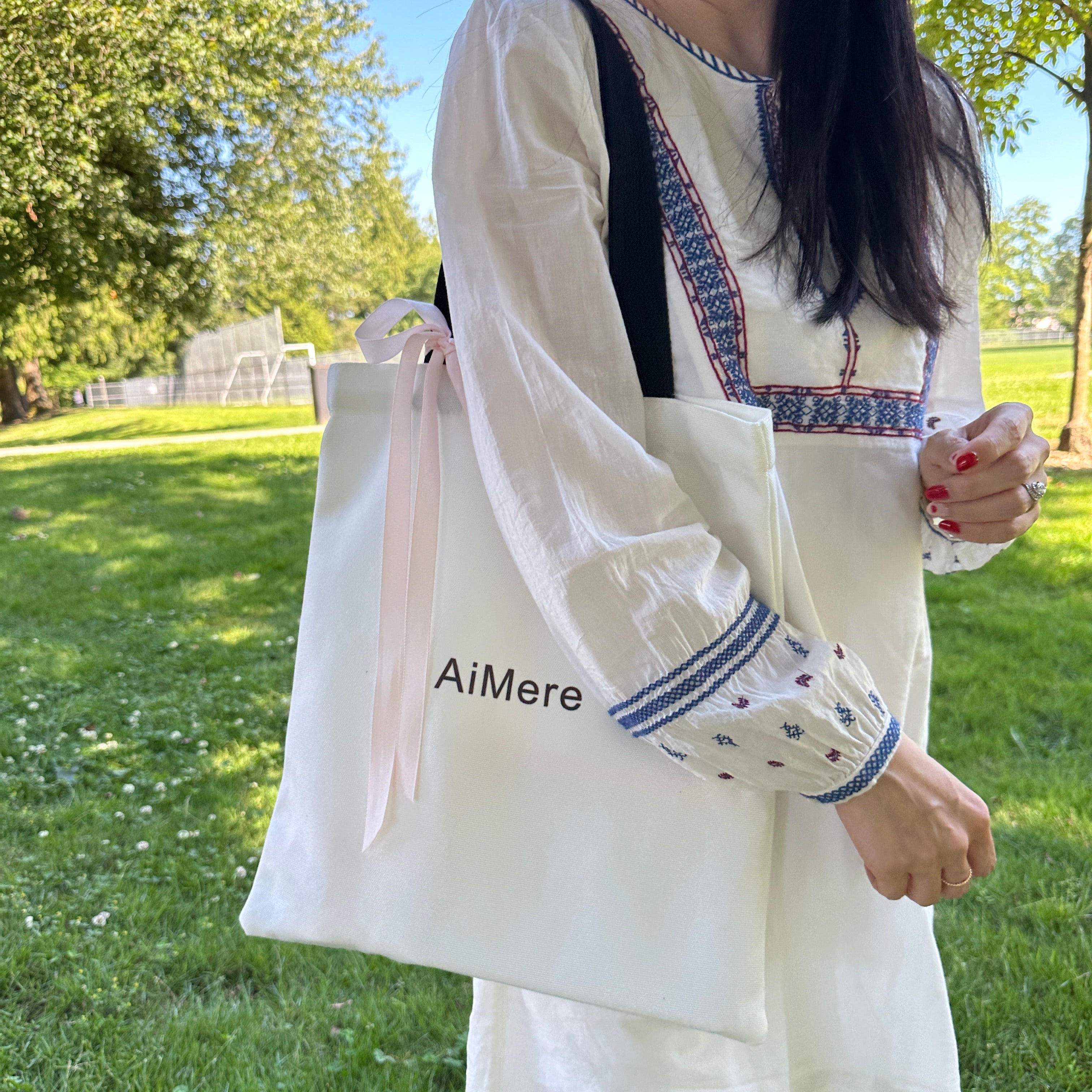 Person holding a white garment with 'Almere' branding against a green outdoor background. Summer outfit. Picknic canvas tote bag

canvas tote bag, customizable tote, AiMere tote, designer bag protection, everyday carry, DIY tote bag, travel tote, work bag, grocery tote